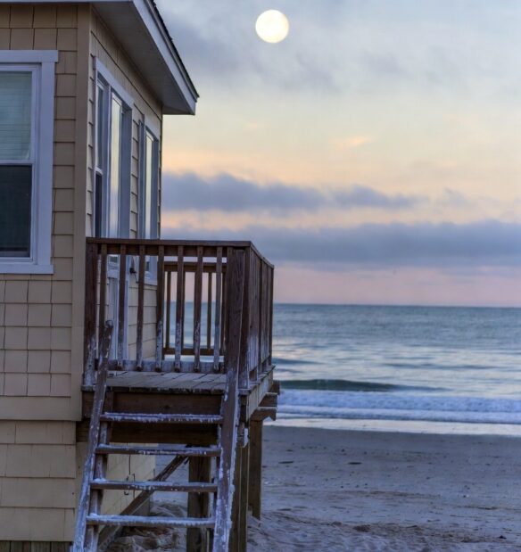 beach house with visible salt buildup on railings